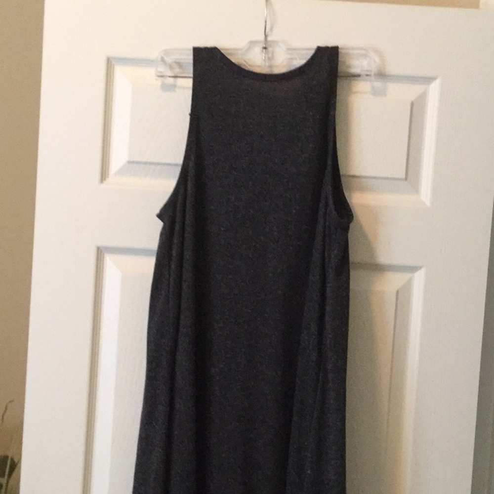 Dark grey, high neck with cut in shoulders.